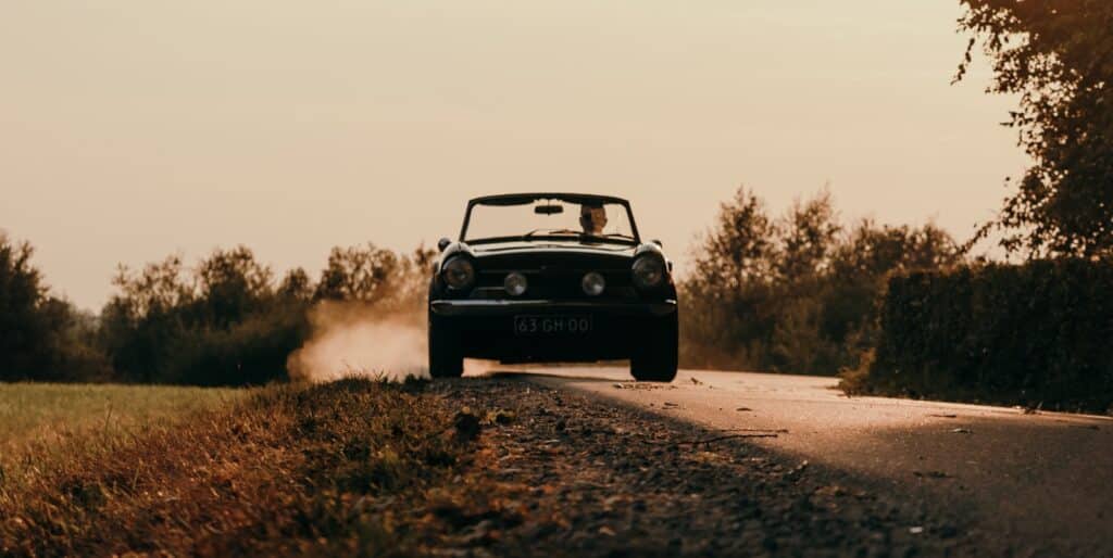 a car driving on a dirt road